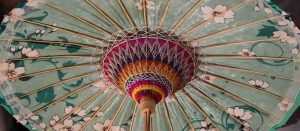 Intricately crafted oil-paper umbrella with bamboo frame and water-resistant paper cover, displaying traditional Chinese craftsmanship.