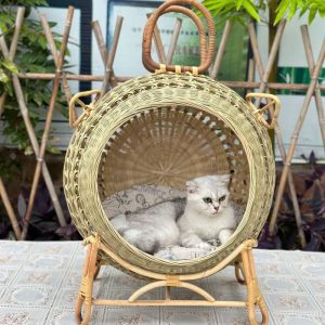 A trendy bamboo-woven cat house with rounded semi-open design, four-legged stand, ideal for all seasons pet bed.